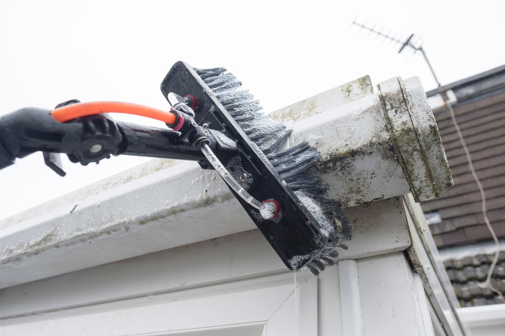 A Brush Cleaning Dirty Clogged White Plastic Pvc Gutters