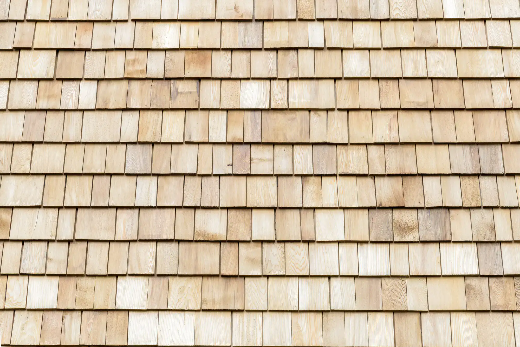 Closeup of cedar siding installation by SkyLuxe Construction in Suffolk County, NY, showcasing the natural texture and durability of the wood
